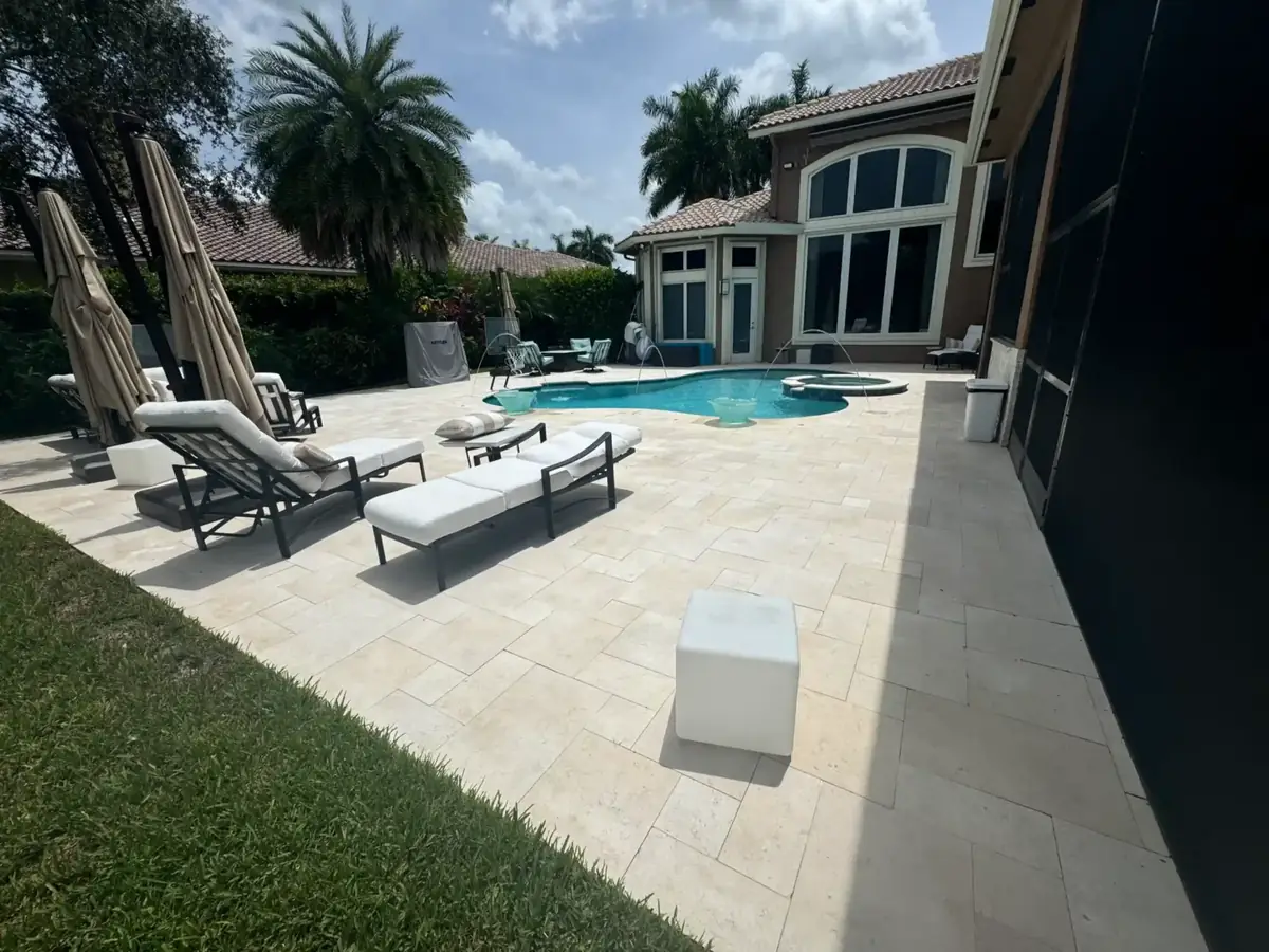 The same pool deck after the French pattern travertine remodel